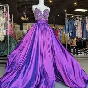 Purple metallic ballgown by Rachel Allan.